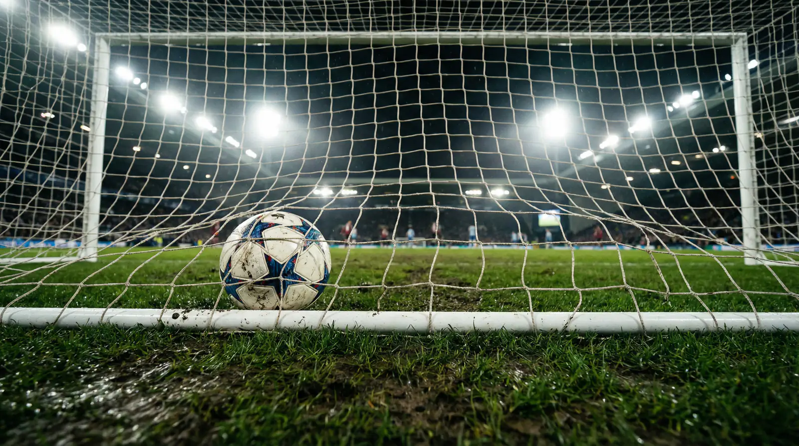 Red de una portería de fútbol vista de cerca con el balón justo cruzando la línea de gol